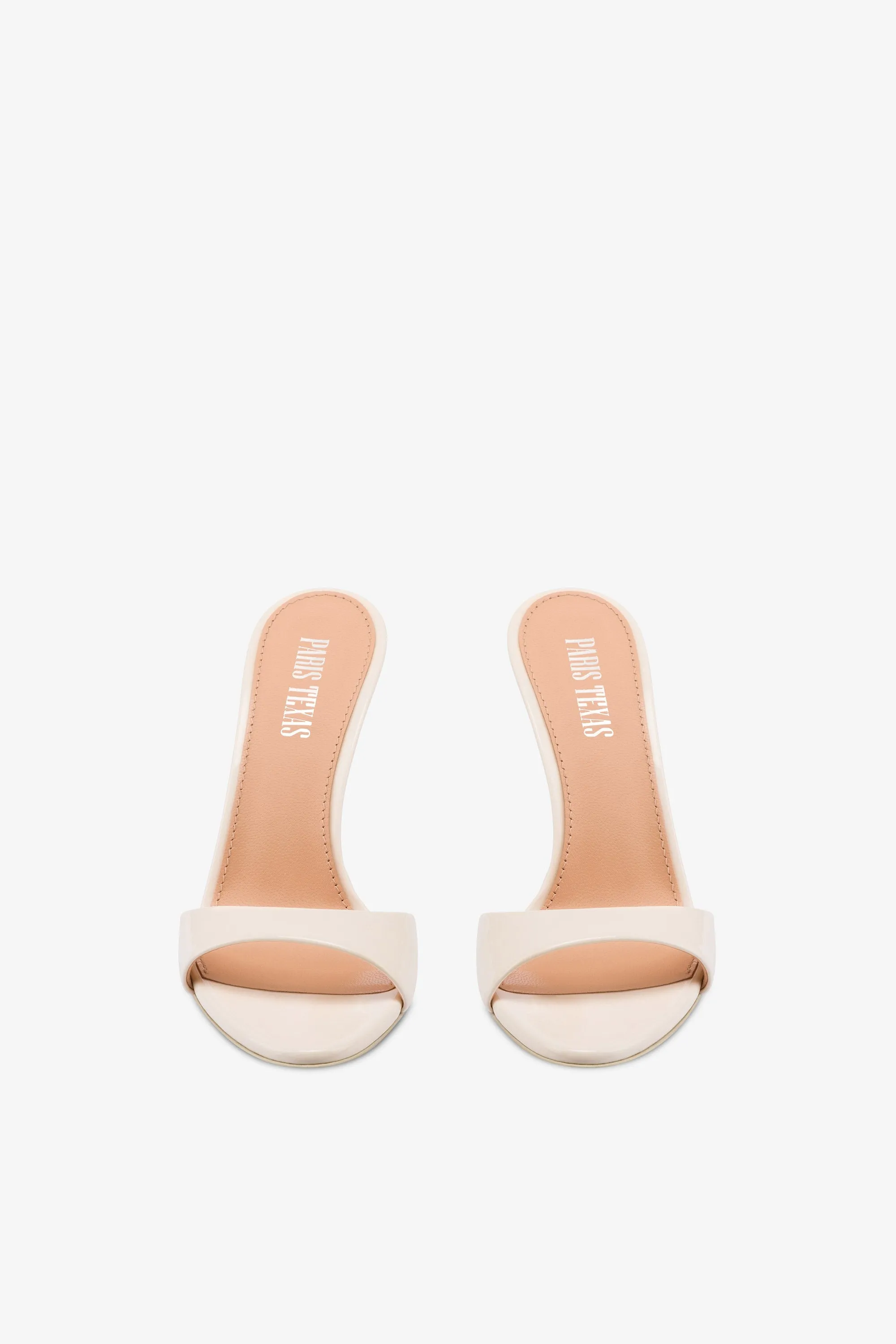Mules in ivory patent leather